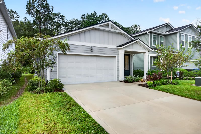 Front exterior from front walkway, trees in yard at 93 Lochloosa Ct, St. Johns, FL 32259