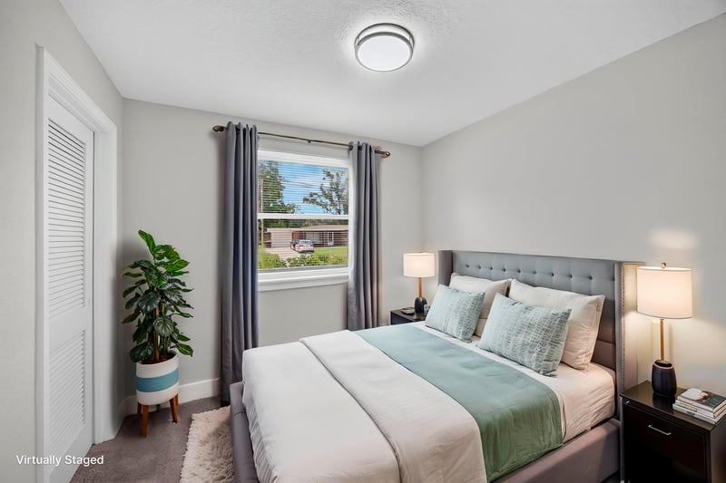 Bedroom with staged bed and window at 6238 Randia Dr, Jacksonville, FL 32210