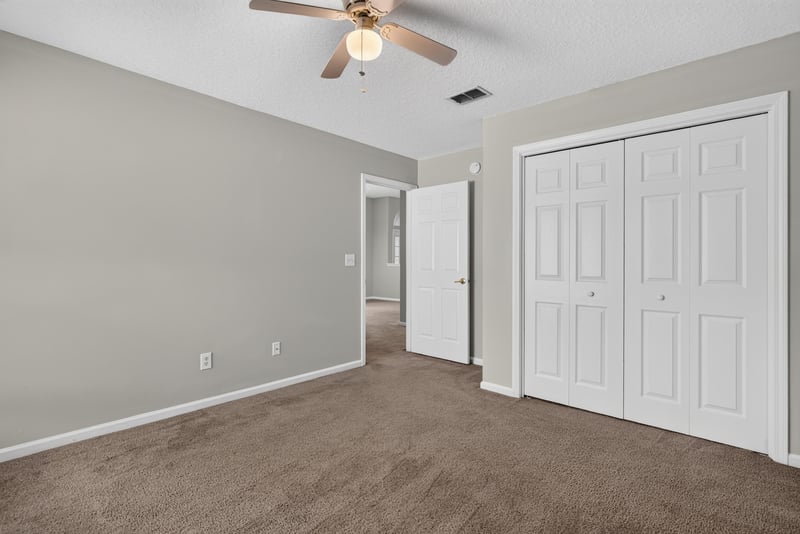 Empty carpeted room with closet doors at 11669 Collins Creek Dr, Jacksonville, FL 32258