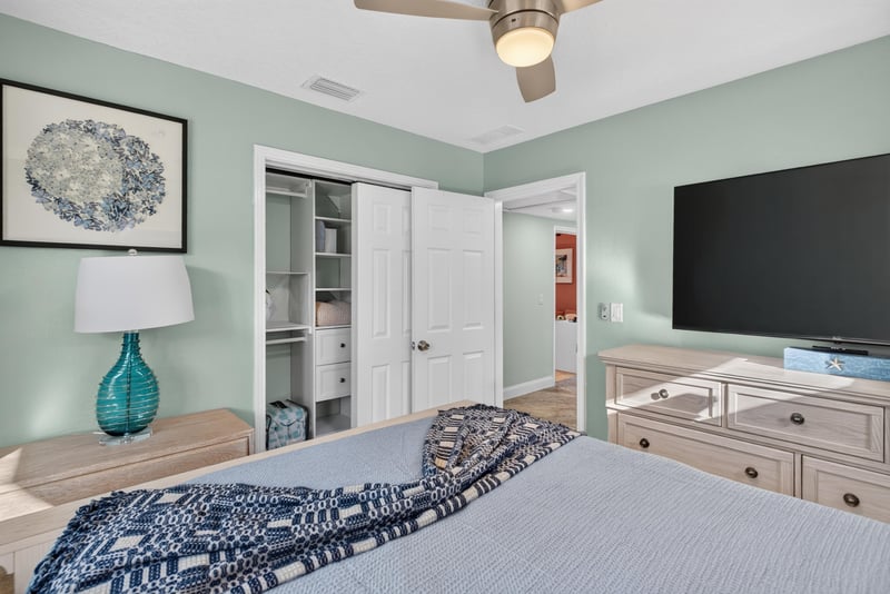 Bedroom with closet and wall-mounted TV at 1525 8th St N, Jacksonville Beach, FL