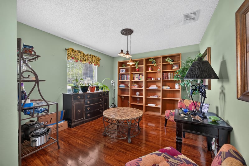 Living room with bookshelf and seating at 145 Dover Bluff Dr, Orange Park, FL