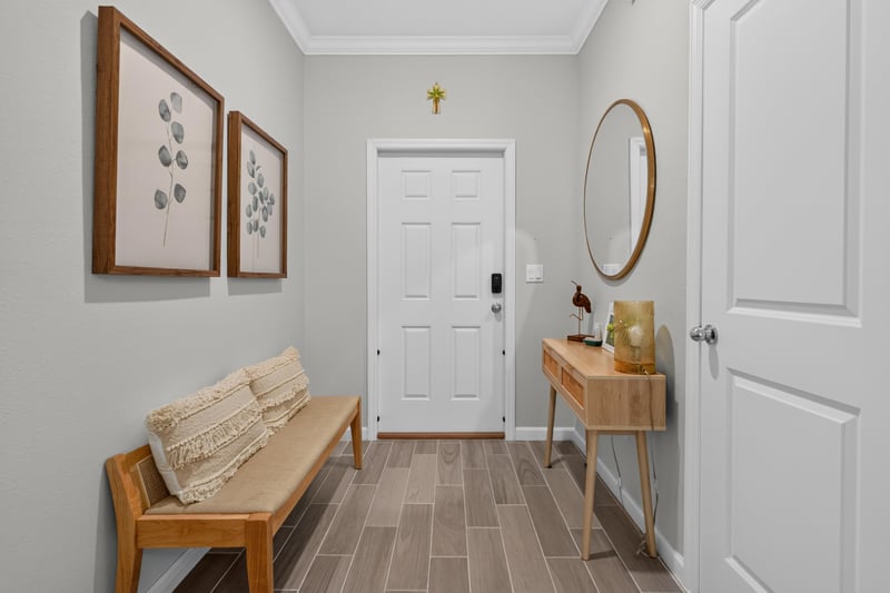 Foyer with bench seating and round mirror at 1186 Beach Dune Dr, Jacksonville, FL 32233