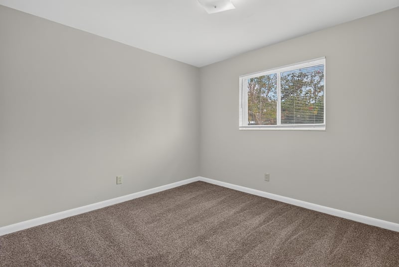 Carpeted bedroom with window at 2618 Arlex Dr E, Jacksonville, FL