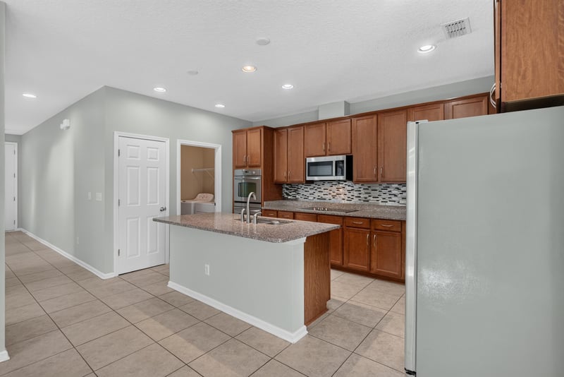 Kitchen with center island and stainless appliances at 13685 Goodson Pl, Jacksonville, FL 32226