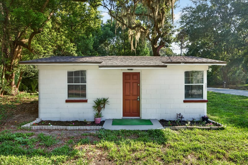 Front exterior angled view with red door at 4951 Halls Dr