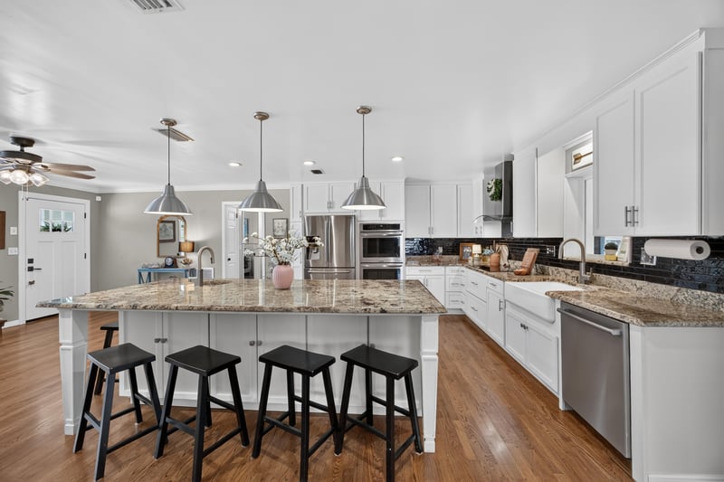 Kitchen with island seating and view to back door at 5843 Ovella Rd, Jacksonville, FL 32244