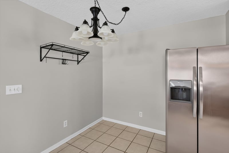 Kitchen nook with pendant light and refrigerator at 11669 Collins Creek Dr, Jacksonville, FL 32258