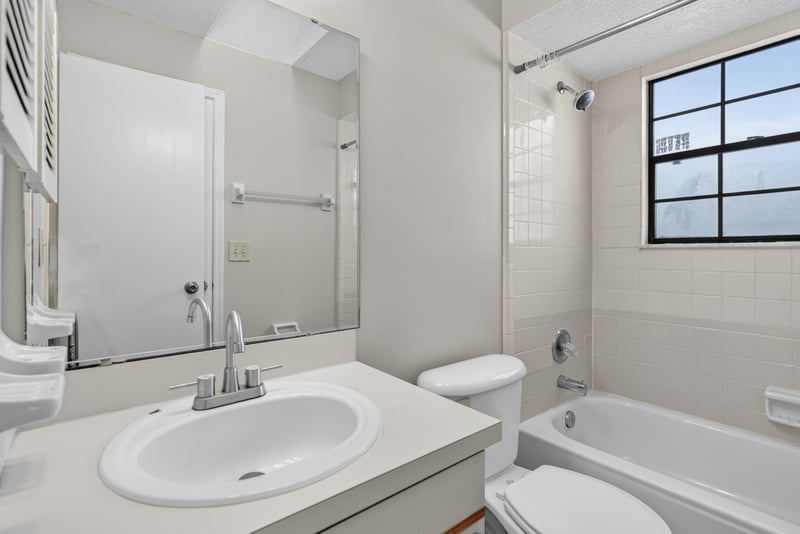 Bathroom with tub and window at 8010 International Village Dr, Jacksonville, FL 32277