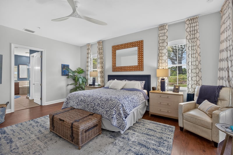 Bedroom with blue and white bedding and seating area at 140 Ave De La Mer, Palm Coast, FL 32137