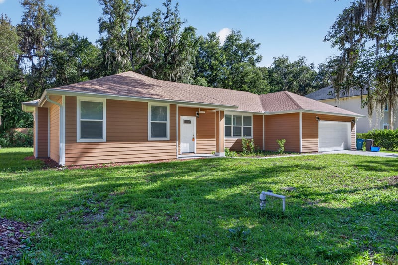 Front exterior closer angle showing brick accents and lawn at 1012 Fruit Cove Rd, Jacksonville, FL 32259