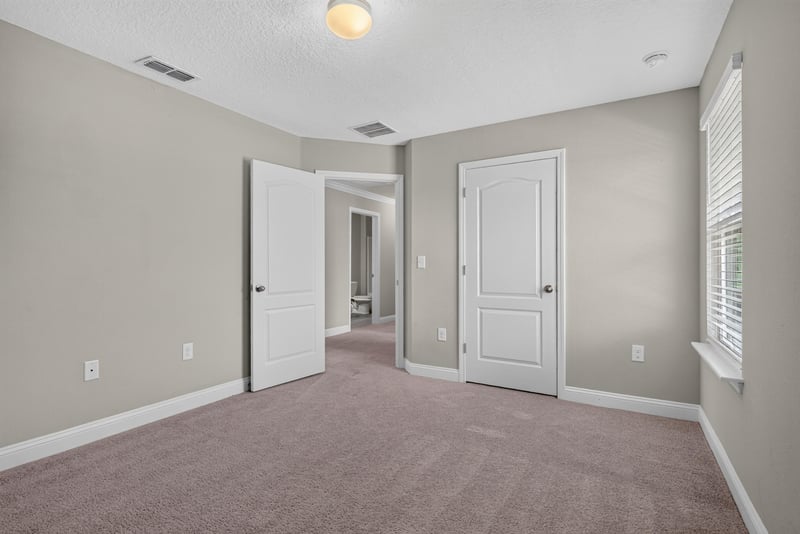 Hallway with carpet and white doors at 2580 Cold Stream Ln, Green Cove Springs, FL 32043