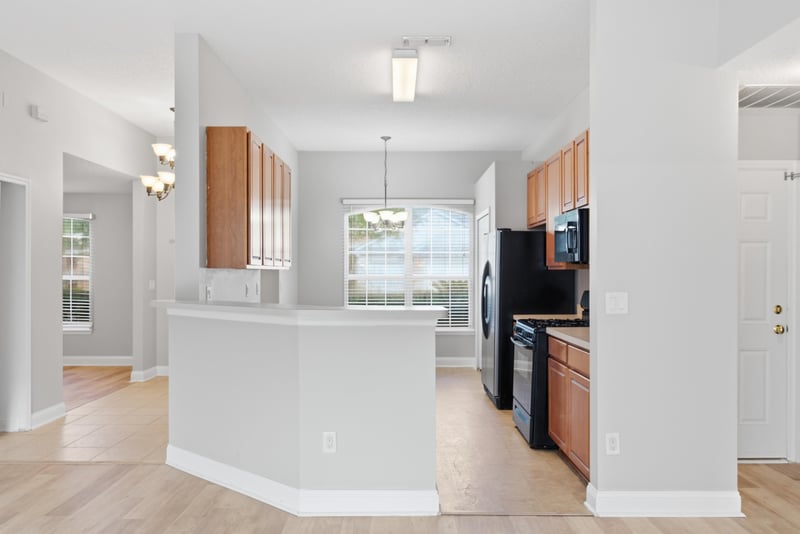 Kitchen with breakfast bar and wood cabinets at 14187 Big Spring St, Jacksonville, FL 32258