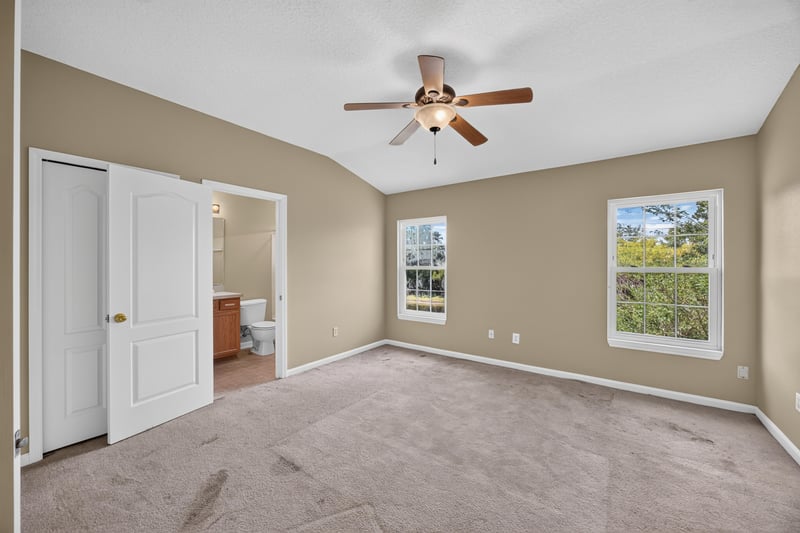 Bedroom with carpet and doorway to ensuite bathroom at 1572 Biscayne Bay Dr, Jacksonville, FL 32218