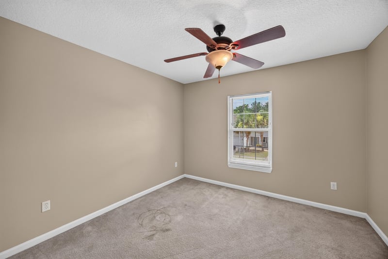 Bedroom with carpet and ceiling fan at 1572 Biscayne Bay Dr, Jacksonville, FL 32218