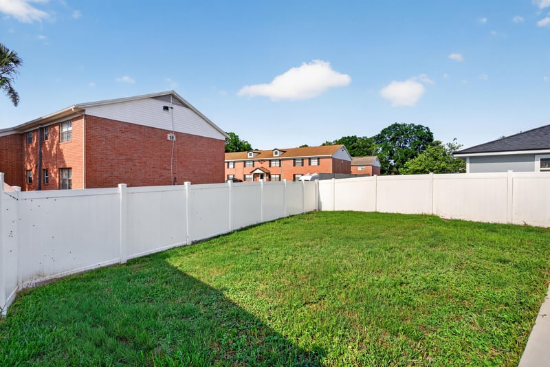 Backyard lawn with fence at 7253 Townsend Village Ct, Jacksonville, FL