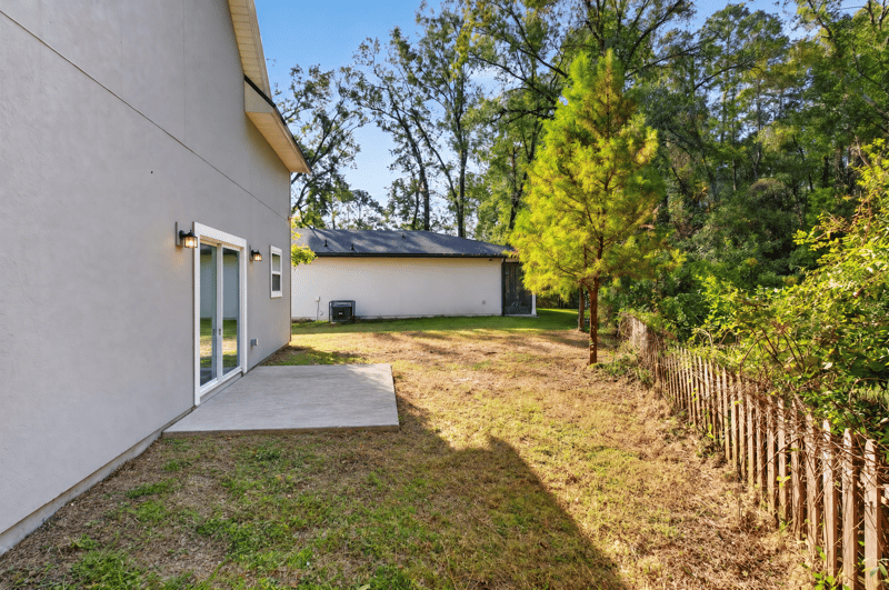 Side exterior with concrete patio, photographed by Megapixeler on Lem Turner Rd, Jacksonville
