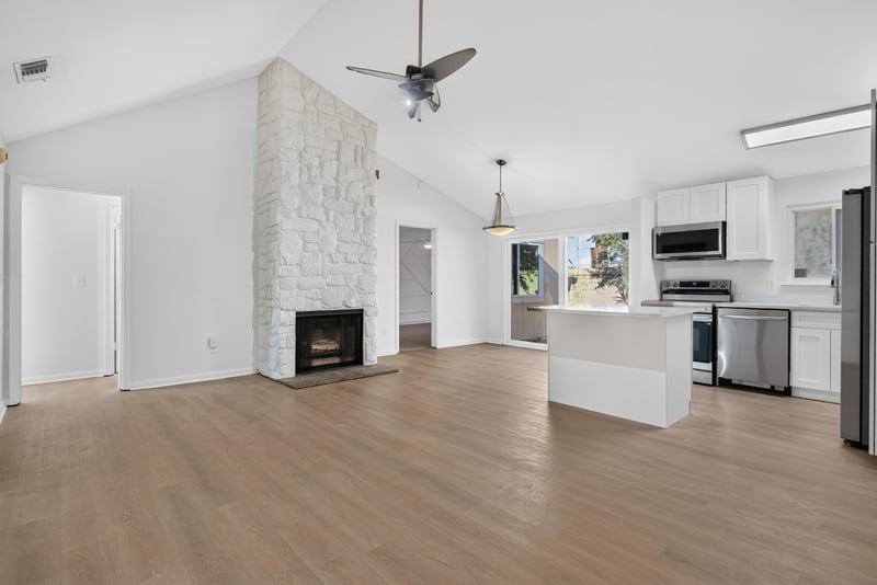 Living room with stone fireplace, virtually staged at 8177 Virgo St, Jacksonville, FL 32216