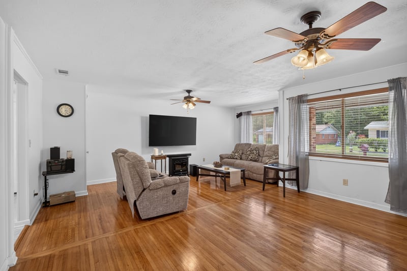 Living room with mounted TV and sofa at 1847 Grove Park Dr, Orange Park, FL