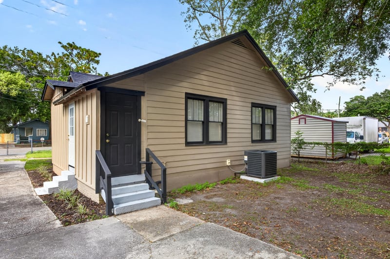 Small accessory structure with wood siding and black door at 316 W 41st St, Jacksonville, FL 32206