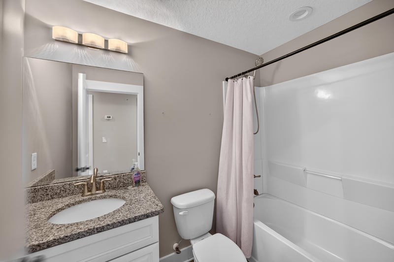 Bathroom vanity with granite counter and shower curtain at 2855 N 8th St, St. Augustine, FL 32084