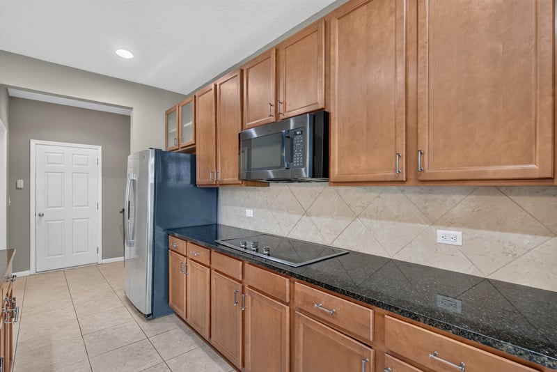 Kitchen cabinets with cooktop and stainless appliances at 263 Gilmore Ln, Orange Park, FL 32065