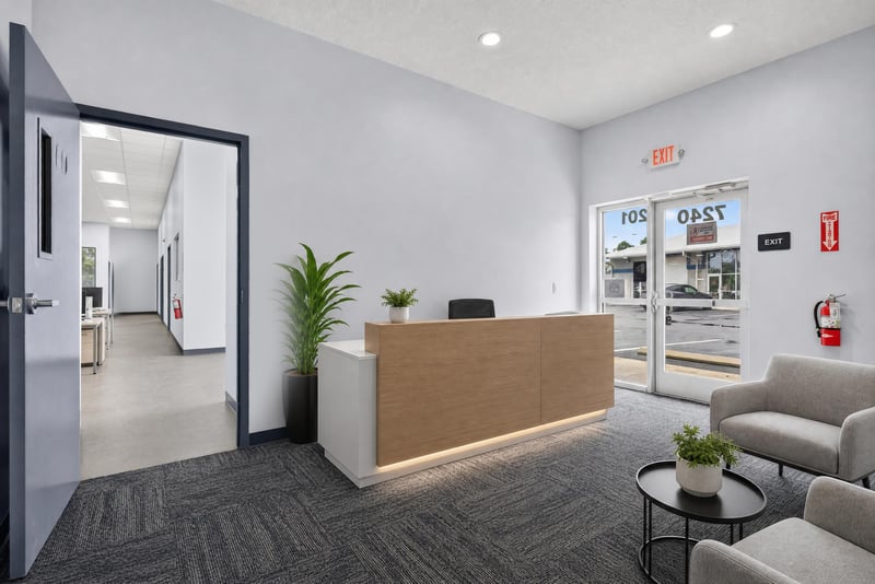 Staged reception desk with seating and storefront windows at 7240 Golden Wings Rd building 100, Jacksonville, FL 32244
