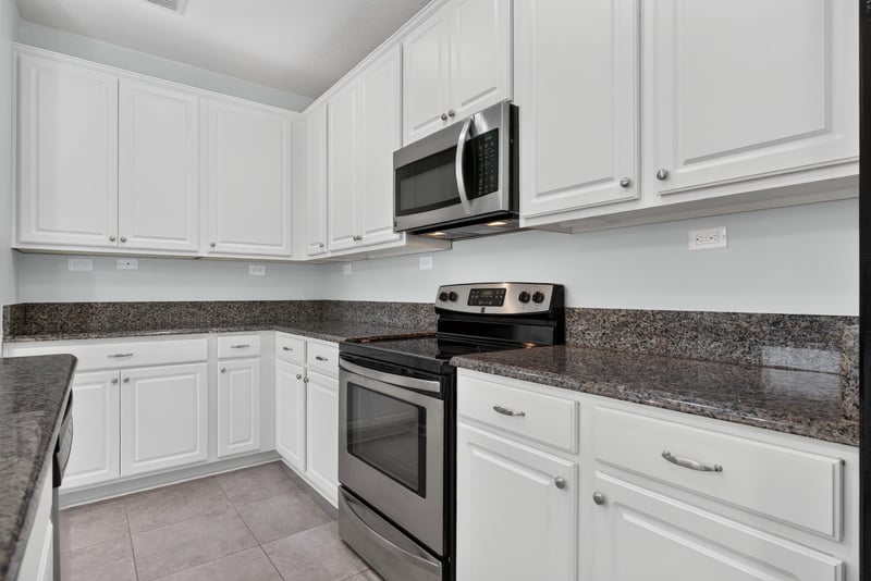 Kitchen counter and range with granite countertops at 2378 Caney Oaks Dr, Jacksonville, FL
