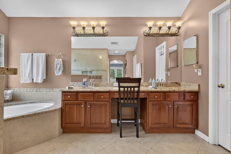 Primary bathroom with dual vanities and soaking tub at 2304 Spring Hill Ct, Orange Park, FL