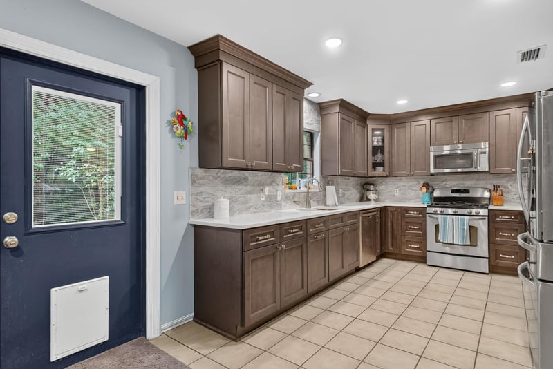Kitchen with dark wood cabinets and tile flooring at 3249 Maryland Ave, Green Cove Springs, FL