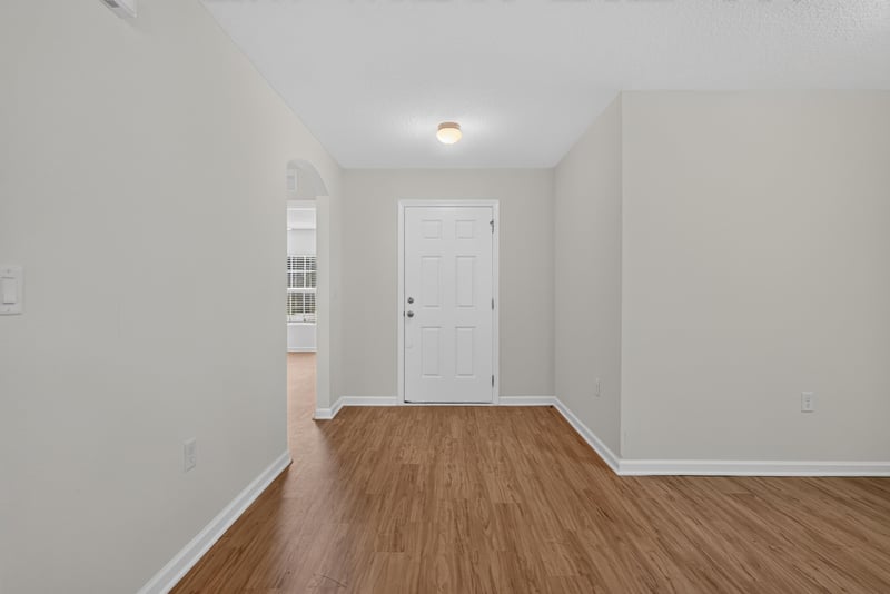 Hallway with closet doors and wood flooring at 95221 Siena Ct, Fernandina Beach, FL 32034