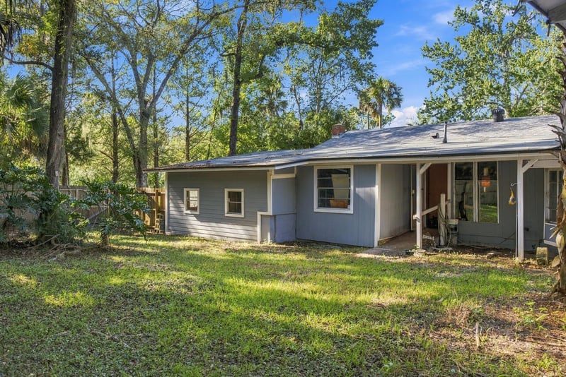Side yard with open grass and trees at 1807 Idlewild Ave, Green Cove Springs, FL
