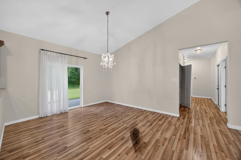 Living room with chandelier and curtained window at 1012 Fruit Cove Rd, Jacksonville, FL 32259