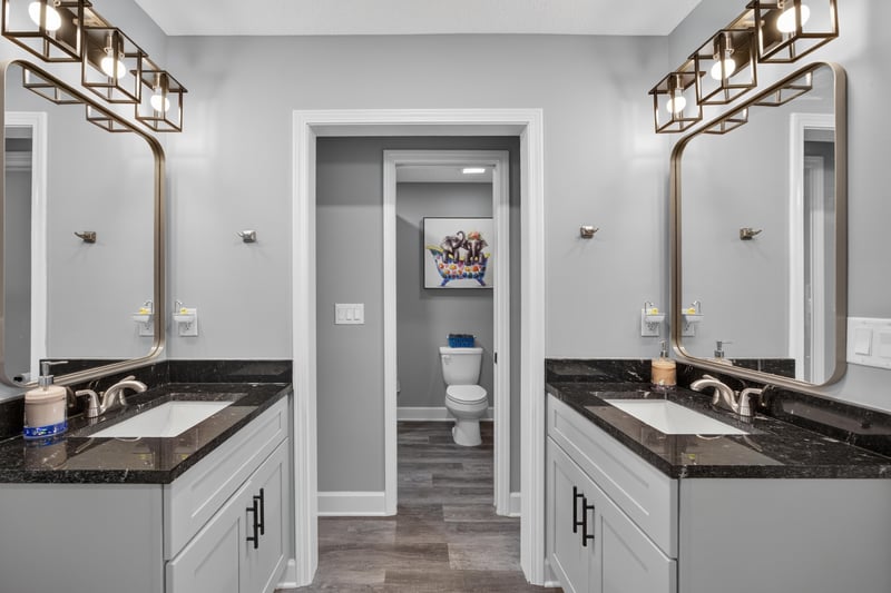 Bathroom with double vanity and hallway view at 2817 Camel Cir, Middleburg, FL