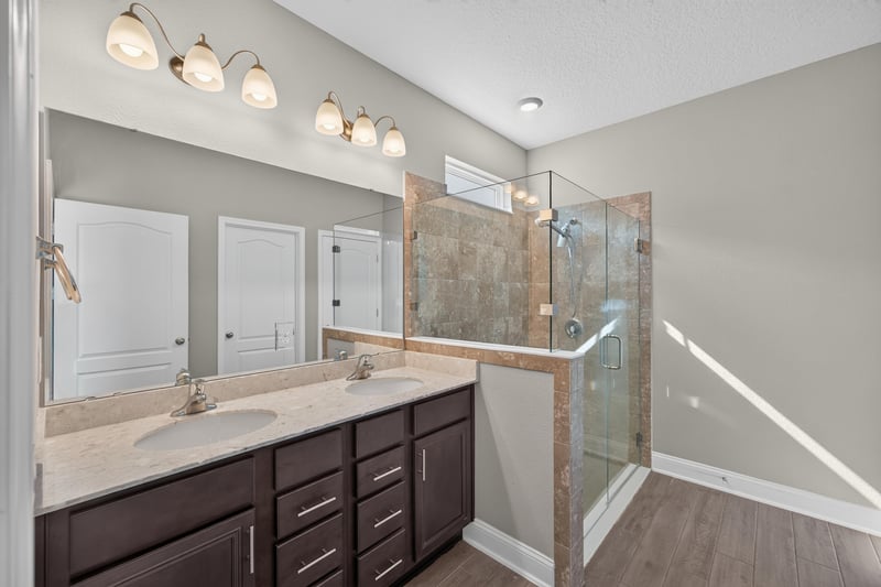 Bathroom with double vanity and glass shower at 331 Millerstone Dr, St. Augustine, FL 32092