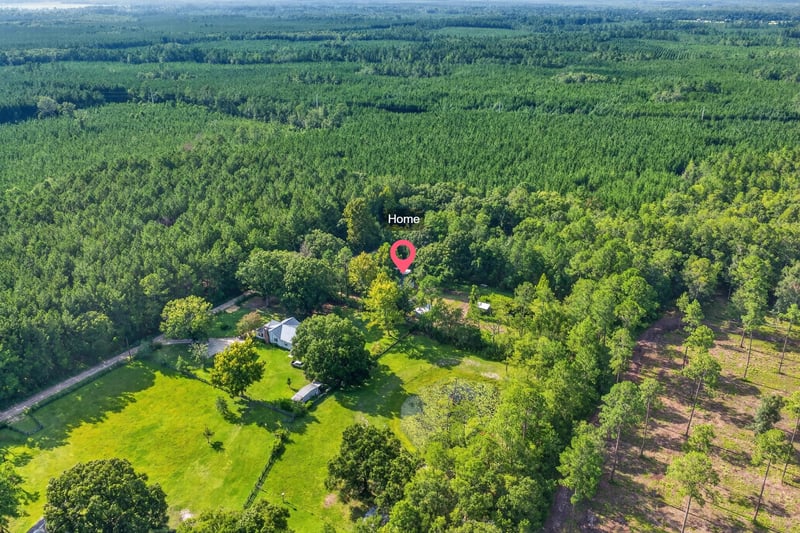 Aerial view of the property's wooded setting at 55520 Jewel-Thomas Rd, Callahan, FL 32011