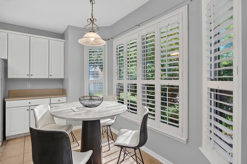 Breakfast nook with round table and plantation shutters at 470 Sparrow Branch Cir, Jacksonville, FL 32259