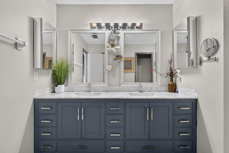 Bathroom double vanity with mirrors at 8680 Bandera Cir S, Jacksonville, FL 32244
