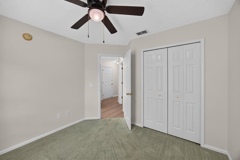 Secondary bedroom with closet and hallway access at 605 N Covered Bridge Rd, Jacksonville, FL