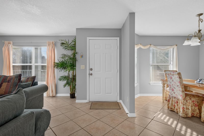 Entry foyer with front door and accent chair at 206 16th St, St. Augustine, FL 32080