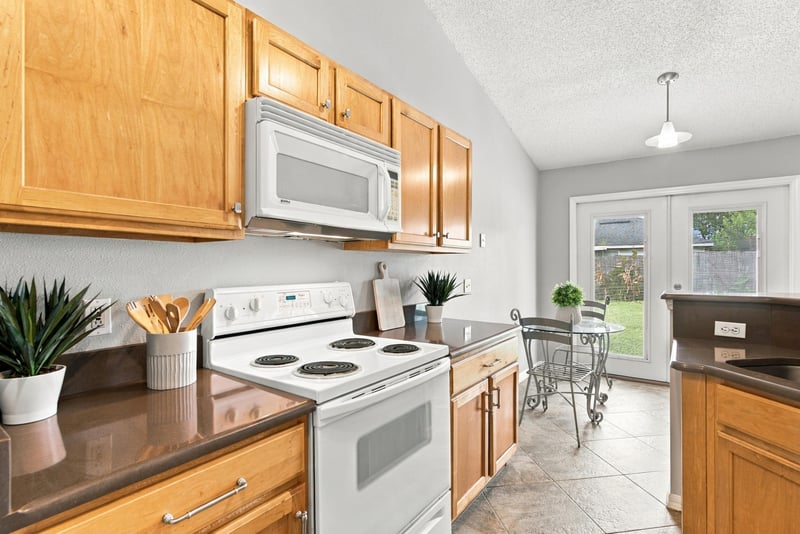Kitchen with white range and wood cabinets at 11197 Illford Dr