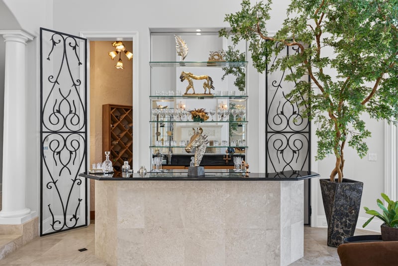 Wine bar with glass shelving and wrought iron doors at 344 Broward Rd, Jacksonville, FL