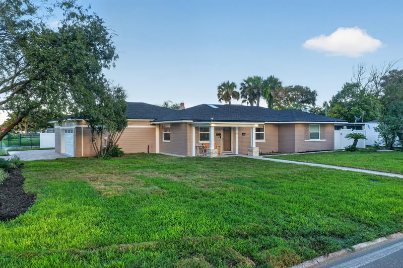 Front exterior with palm trees at day-to-dusk at 1525 8th St N, Jacksonville Beach, FL
