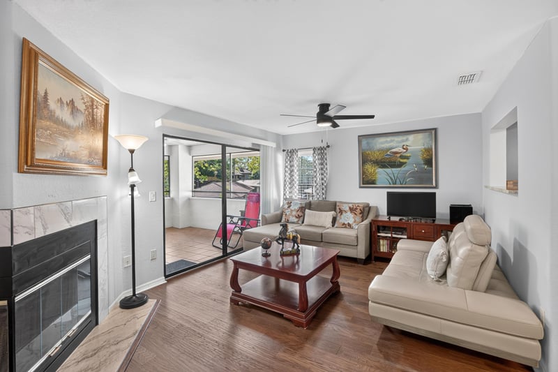 Living room with fireplace and sliding glass doors at 10150 Belle Rive Blvd, Jacksonville, FL