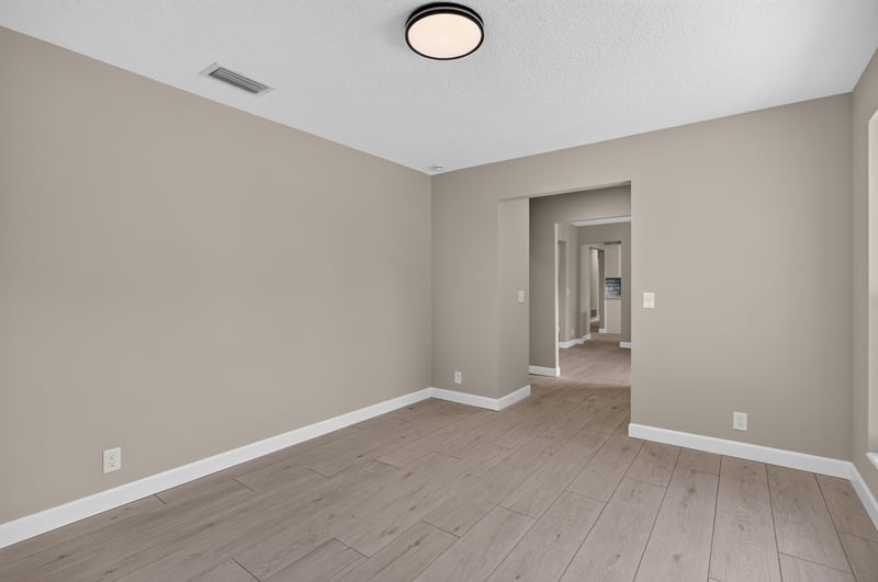 Hallway view with wood-look flooring and white trim at 4117 Wilcrest Ct, Jacksonville, FL 32277