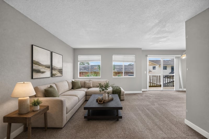 Virtually staged living room with sofa and wall art at 1800 Park Ave apt 358, Orange Park, FL