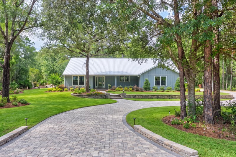 Front exterior wide view with driveway and surrounding trees at 4800 Acacia St, Middleburg, FL 32068