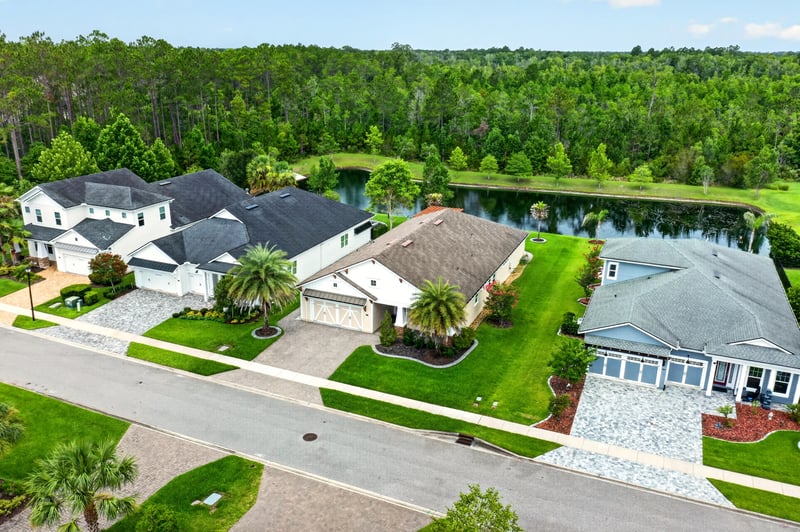 Aerial view of the home near a backyard pond at 186 Freshwater Dr