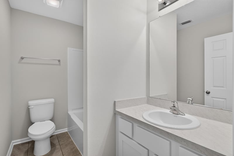 Hall bathroom with toilet and vanity at 4024 Bay Hawk Ct, Jacksonville, FL