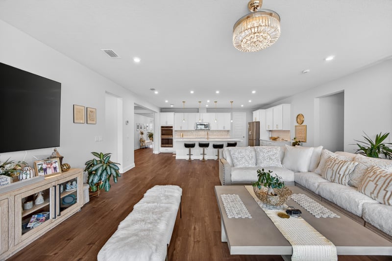 Living room open to the kitchen with sectional sofa at 85491 Fall River Pkwy, Fernandina Beach, FL 32034