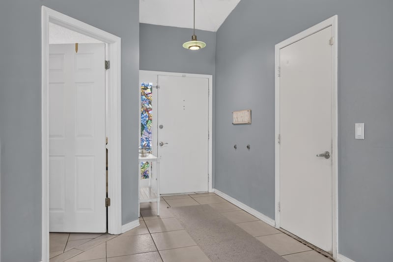 Foyer with stained glass sidelights and front door at 13020 Medford Ln, Jacksonville, FL 32225